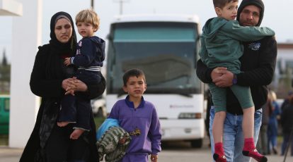 Refugees walk inside the refugee camp in Kokkinotrimithia, outside Nicosia, Cyprus