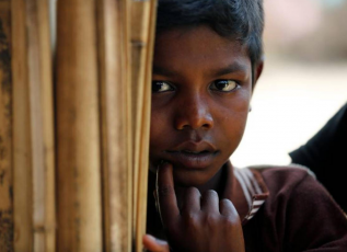 Rohingya refugee boy looks on at Balukhali Makeshift Refugee Camp in Cox's Bazar, Bangladesh.