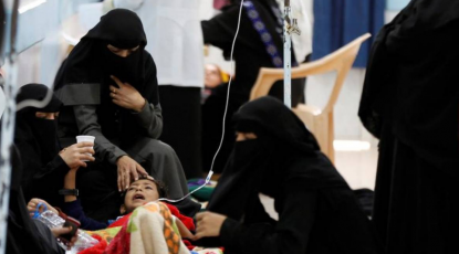 Women help a young relative infected with cholera at a hospital in Sanaa, Yemen