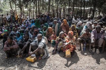 Ethiopians wait for food supplies provided in part by USAID.