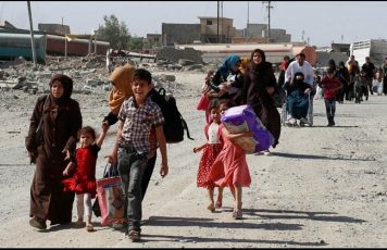 Residents who fled their homes due to fighting between Iraqi forces and ISIS militants return to their village cleared by the Iraqi forces in western Mosul in Iraq.
