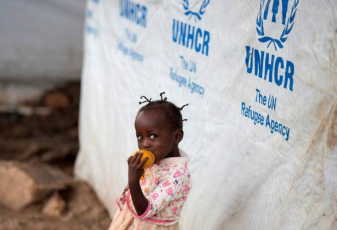 A girl eats a mango at a shelter for displaced people in Bangui, Central African Republic,