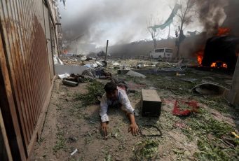 A wounded man lies on the ground at the site of a blast in Kabul, Afghanistan.