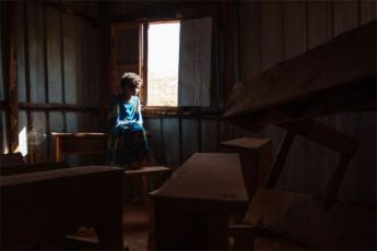 Nasibo, 6, sits in an abandoned safe space for children in Doolow, Somalia.