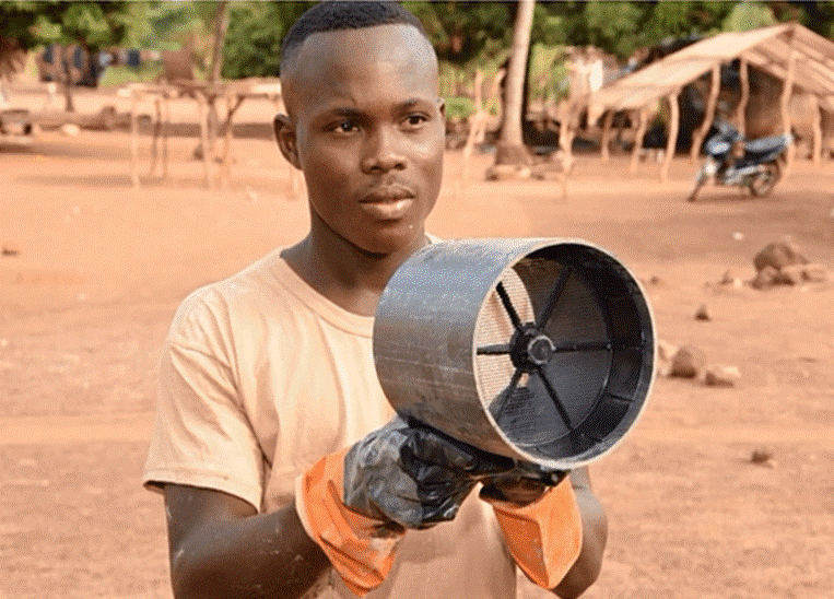 A man in Ivory Coast demonstrates the ventilation pipes